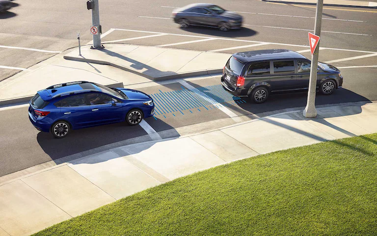 A 2022 Impreza 5-door driving on a highway with blue graphics illustrating the Pre-Collision Throttle management sensors.